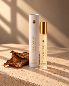 MOD 10 ml perfume and white tube with gold lettering beside a cured tobacco leaf on warm ivory stone